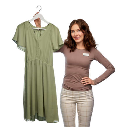 happy female shop assistant with dress on hanger