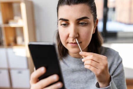 woman making self testing coronavirus test at home