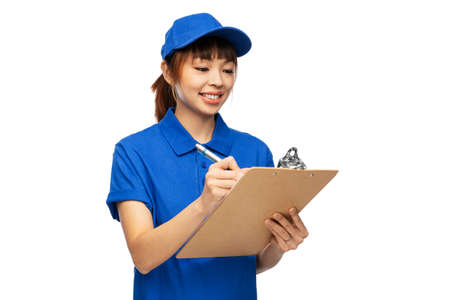 happy delivery woman with clipboard and penの写真素材
