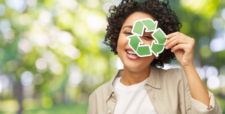 happy woman looking through green recycling sign