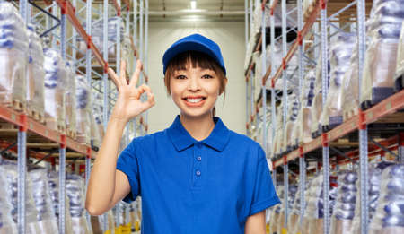 happy smiling delivery woman showing ok gestureの写真素材