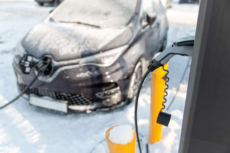 close up of electric car charging in winterの写真素材