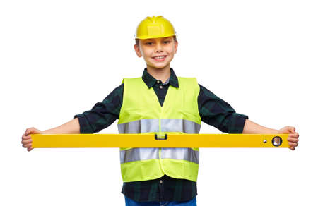boy in construction helmet and vest with level