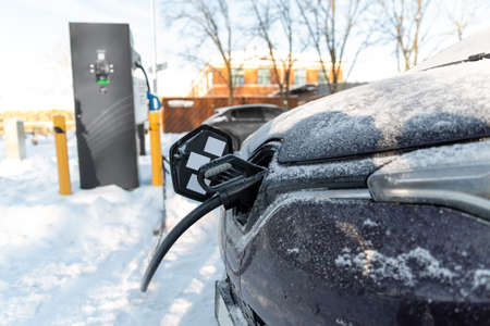 close up of electric car charging in winterの写真素材
