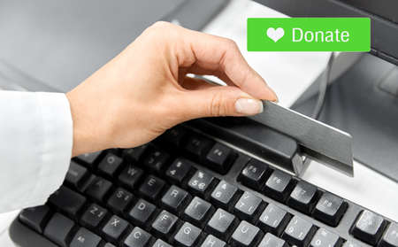 hand with credit card making donation onlineの写真素材