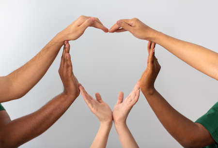 close up of hands making heart gesture