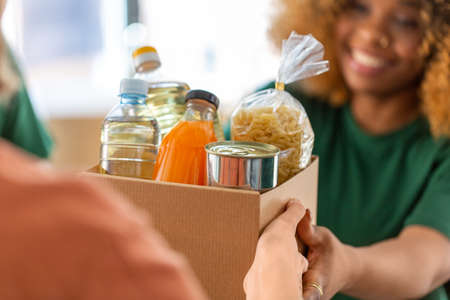 volunteers give food at refugee assistance centerの写真素材