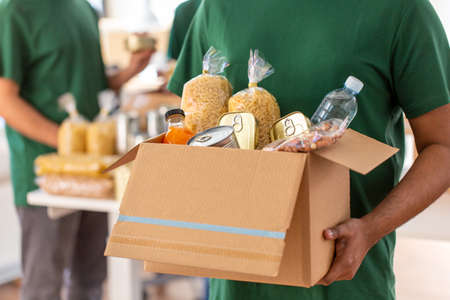 close up of volunteer holding box with food