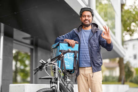 man with food delivery bag and bicycle shows ok