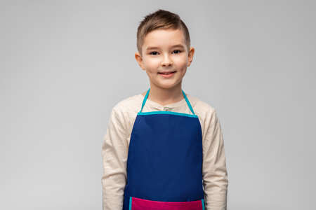 smiling little boy in apronの写真素材