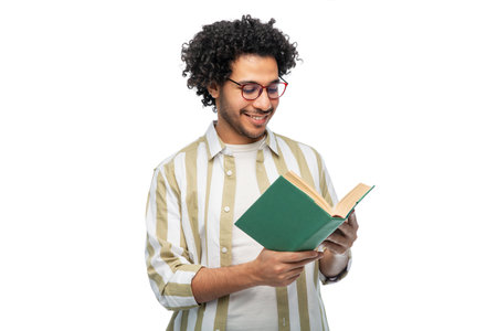 happy young man in glasses reading book