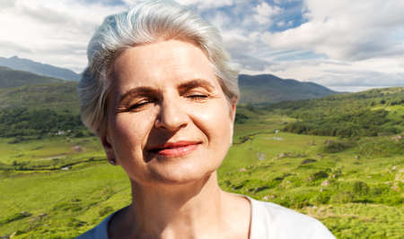 portrait of senior woman enjoying sun on beach