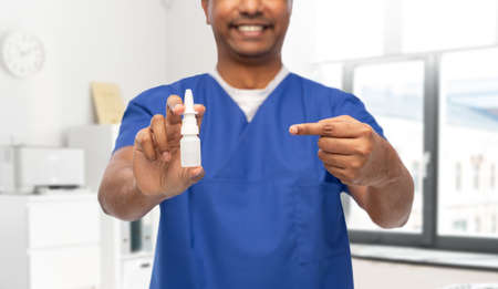 smiling doctor or male nurse with medicine