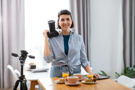 food photographer with camera working in kitchenの写真素材