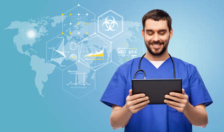 doctor or male nurse with tablet pc over charts