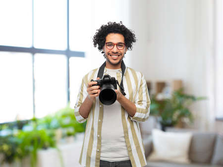 man or photographer with digital camera at homeの写真素材