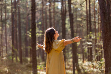 woman or witch performing magic ritual in forestの写真素材