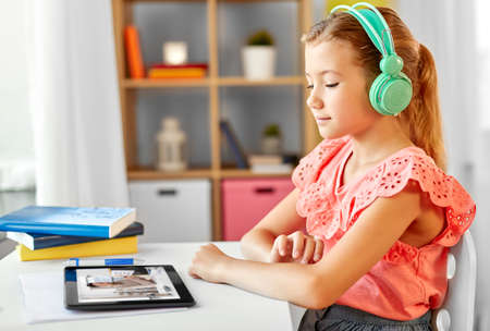 student girl in headphones learning online