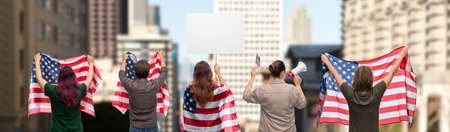 people with poster and flags of america in city