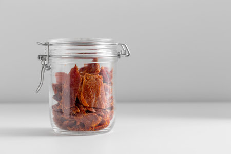 close up of jar with beef jerky or pastrami