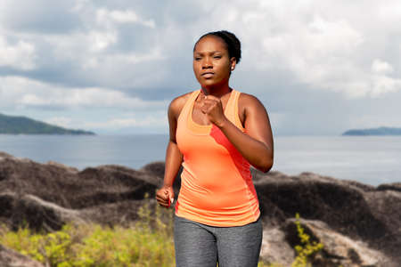 woman running over seychelles island backgroundの写真素材