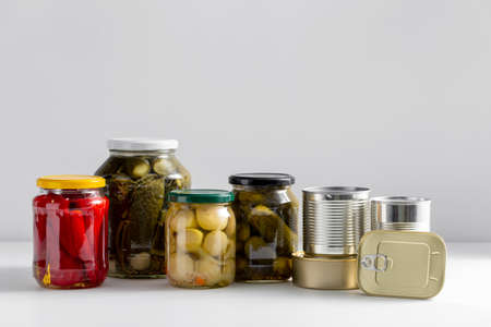 close up of jars and tin cans with preserved foodの写真素材