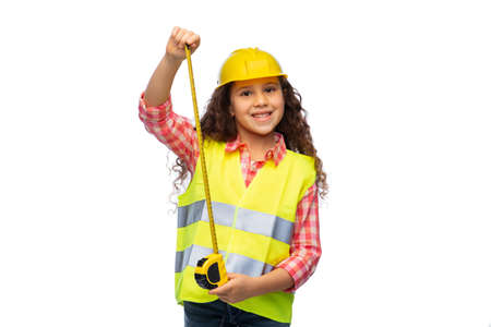 little girl in construction helmet with ruler