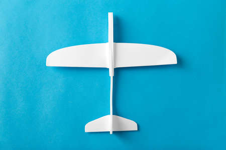 white toy plane model on blue backgroundの写真素材