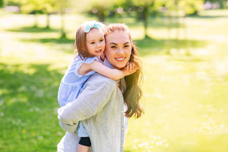 happy mother with little daughter at summer parkの写真素材