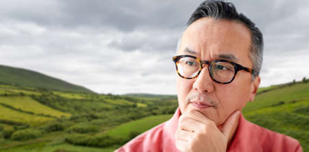 close up of man thinking over irish landscapeの写真素材