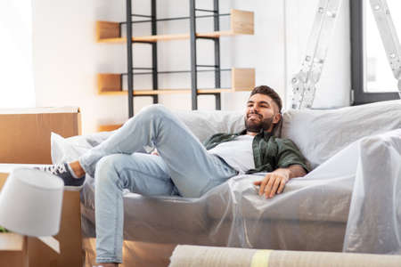 happy man with boxes moving to new home