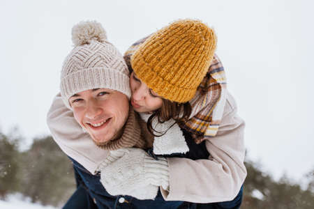 happy couple having fun in winter parkの写真素材