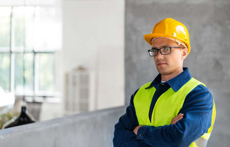male builder in helmet and safety west at officeの写真素材