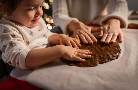 mother and daughter making gingerbread at homeの写真素材