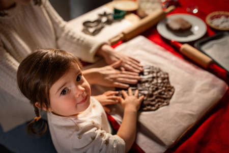 mother and daughter making gingerbread at homeの写真素材