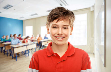portrait of happy smiling student boy at schoolの写真素材