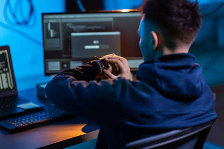 hacker with smart watch and computers in dark roomの写真素材