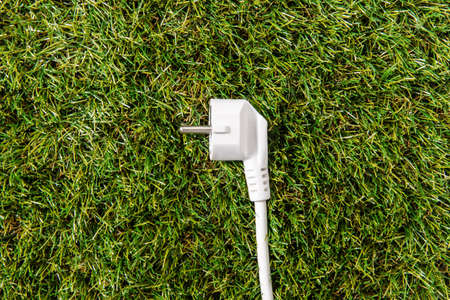close up of electric plug on green grassの写真素材