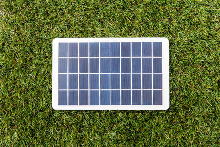 close up of solar battery model on green grassの写真素材