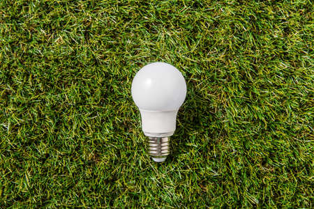 close up of lightbulb on green grass backgroundの写真素材