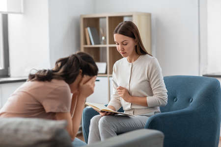 psychologist and woman at psychotherapy sessionの写真素材