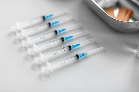 disposable syringes on table at hospitalの写真素材