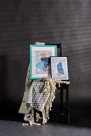 abstract pictures with blanket on black chair