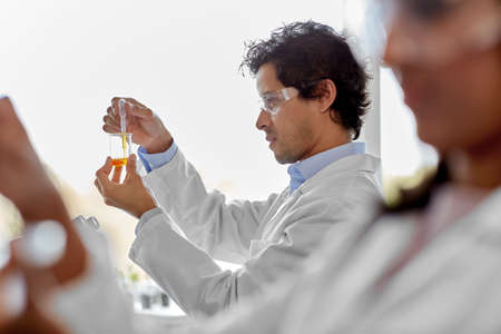 male scientist with chemical working in laboratoryの写真素材