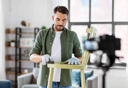 man or blogger showing old chair renovation