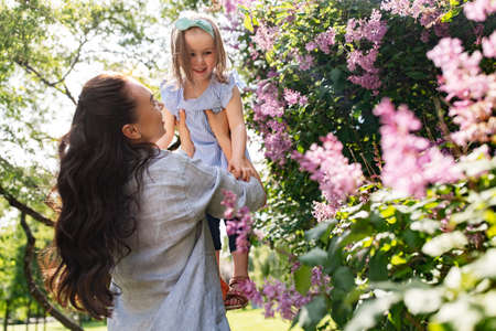 happy mother with little daughter at summer parkの写真素材