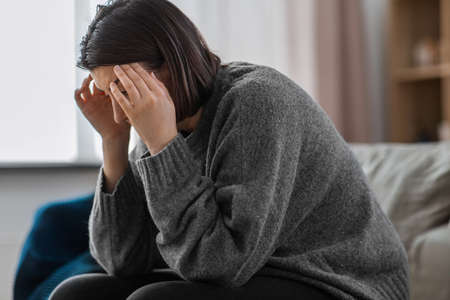 close up of stressed woman having headache at home