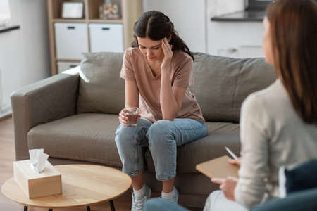 woman and psychologist at psychotherapy sessionの写真素材