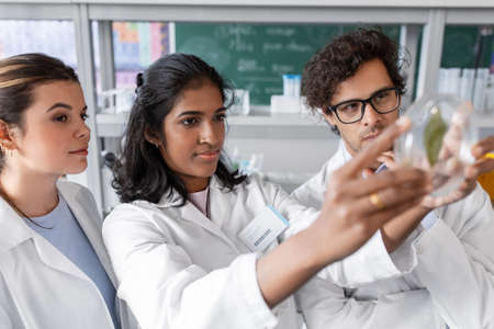 group of scientists with leaf in laboratoryの写真素材