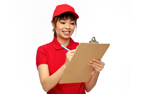 happy delivery woman with clipboard and penの写真素材